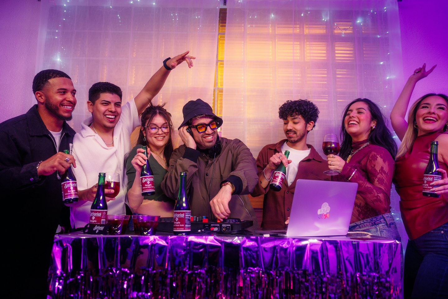 Friends celebrate together at a party with music equipment.